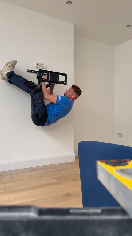 Technician mounting a TV